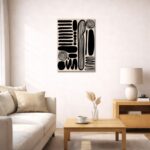 北欧ミニマルなリビング空間に飾られた、ブラックブラッシュ抽象アート（A3サイズ相当）。