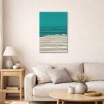 北欧ミニマルなリビング空間に飾られた、ターコイズブルーとブラックラインの水平ライン抽象アート（A3サイズ相当）。