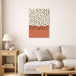 北欧ミニマルなリビング空間に飾られた、テラコッタカラーとブラックドットの抽象アート（A3サイズ相当）。