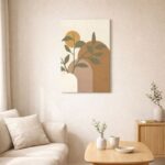 北欧ミニマルなリビング空間に飾られた、オリーブリーフと幾何フォルムのボタニカル抽象アート（A3サイズ相当）。