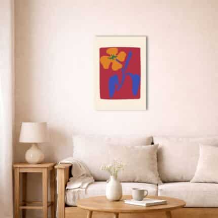 北欧ミニマルな空間に飾られたレッド背景の抽象フラワーキャンバスアート（A3相当）。